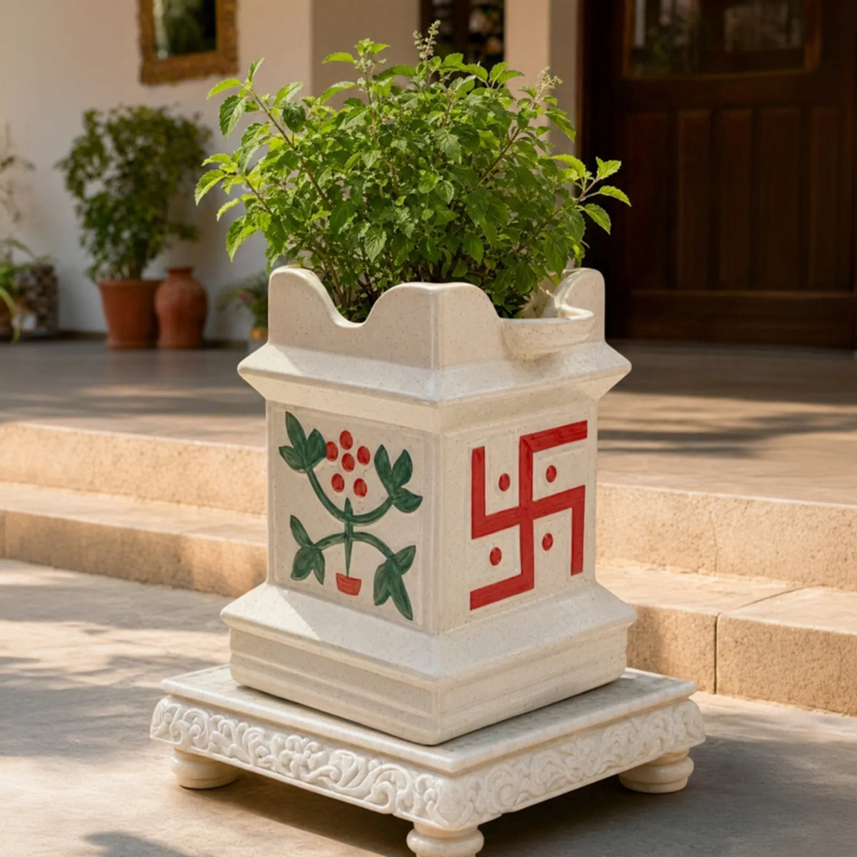 Shubh Vatika ceramic Tulsi planter with Tulsi plant on a marble choki at the entrance