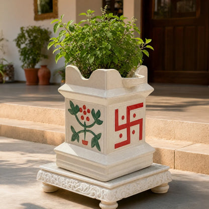 Shubh Vatika ceramic Tulsi planter with Tulsi plant on a marble choki at the entrance